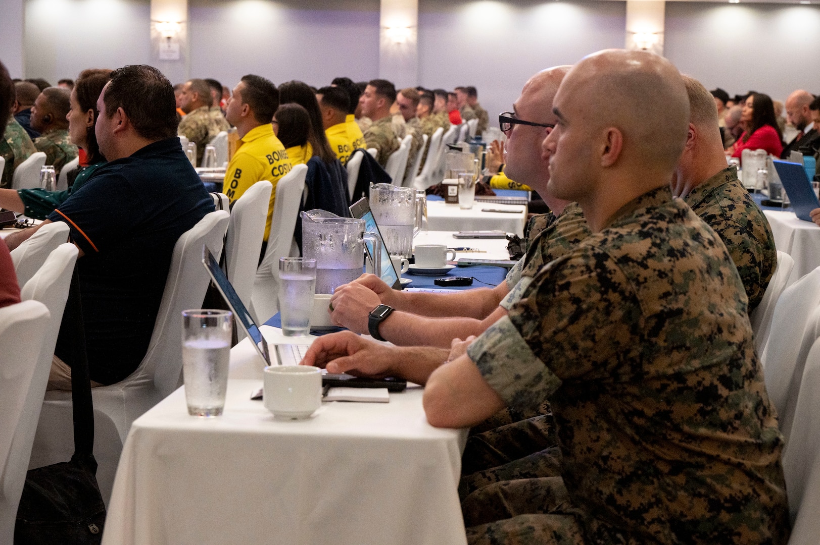 A photo of marines facing forward listening.