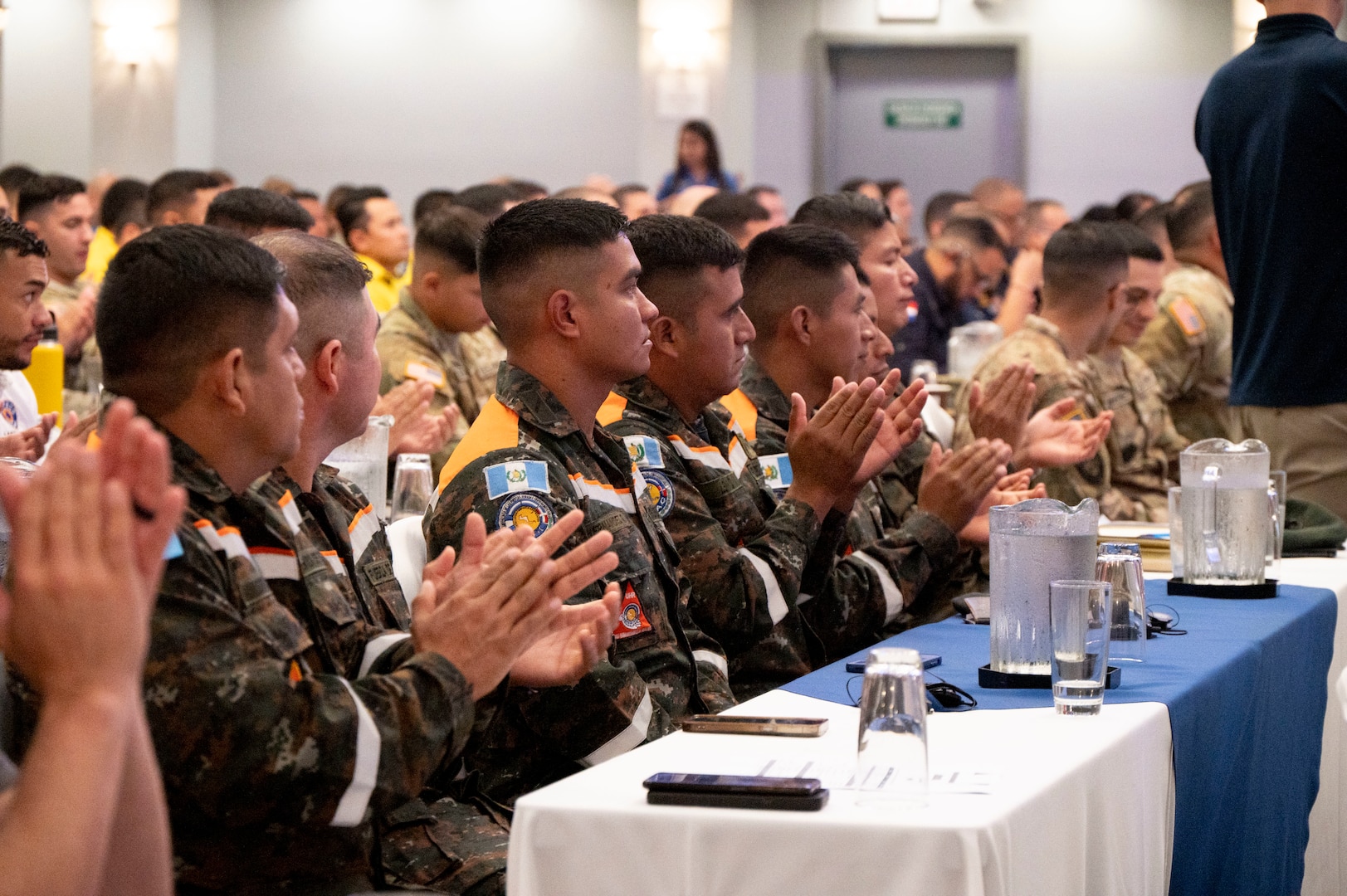 A photo of people clapping.