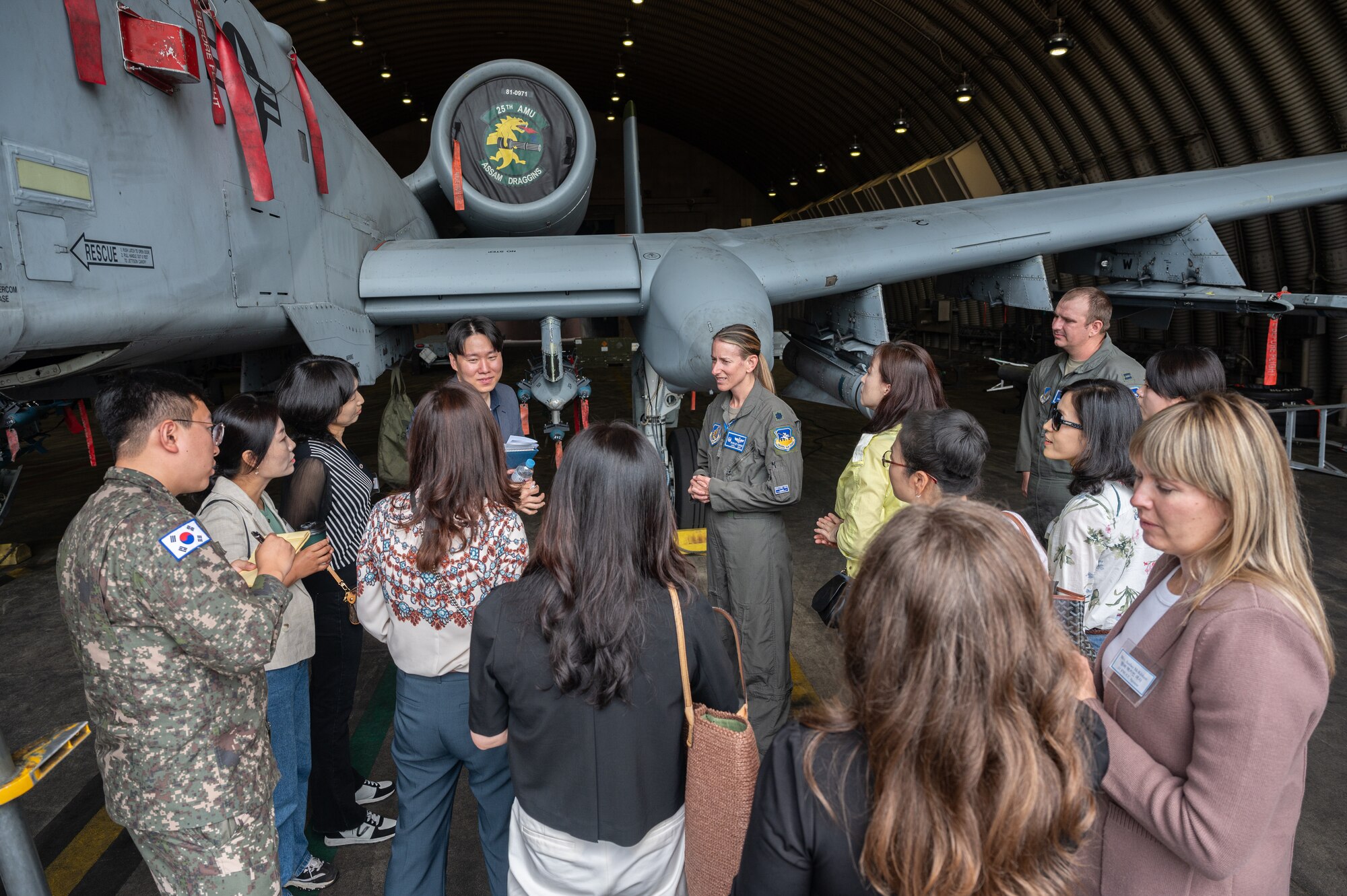 U.S. Air Force Lt. Col. Chandra Fleming, 51st Operations Support Squadron commander, briefs about the A-10C Thunderbolt II to spouses at Osan Air Base, Republic of Korea, May 30, 2024. The spouses groups were briefed as part of an effort to increase relations amongst the organizations while learning about capabilities at Osan. (U.S. Air Force photo by Staff Sgt. Christopher Tam)