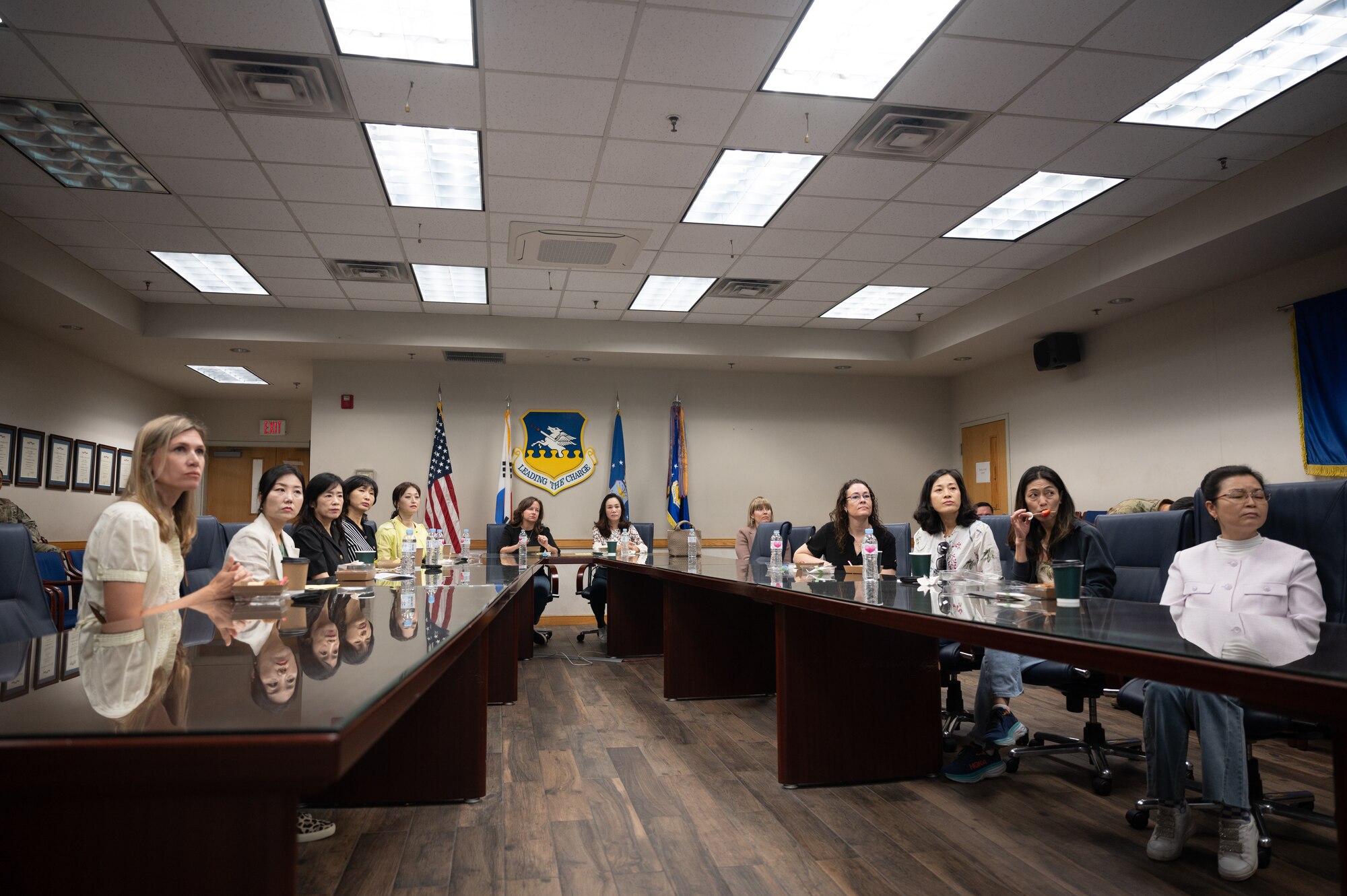 U.S. Air Force and Republic of Korea Air Force spouses, receive a mission brief from the 51st Fighter Wing at Osan Air Base, Republic of Korea, May 30, 2024. The briefing was part of a tour hosted to increase relations between the two spouse groups on base. (U.S. Air Force photo by Staff Sgt. Christopher Tam)