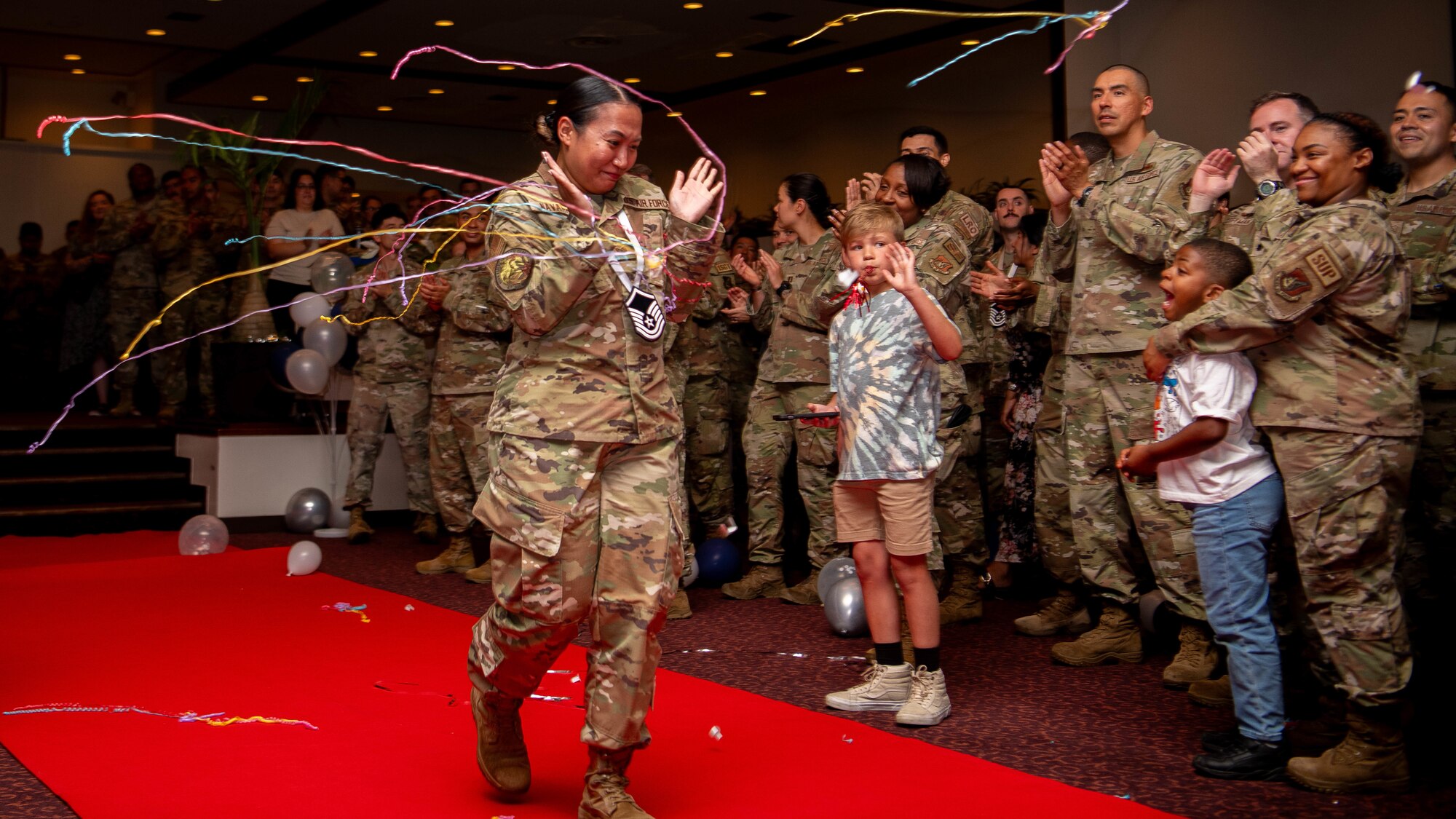 U.S. Air Force Tech. Sgt. Jackieline Navarra, 374th Airlift Wing command chief executive assistant, walks to accept a plaque.