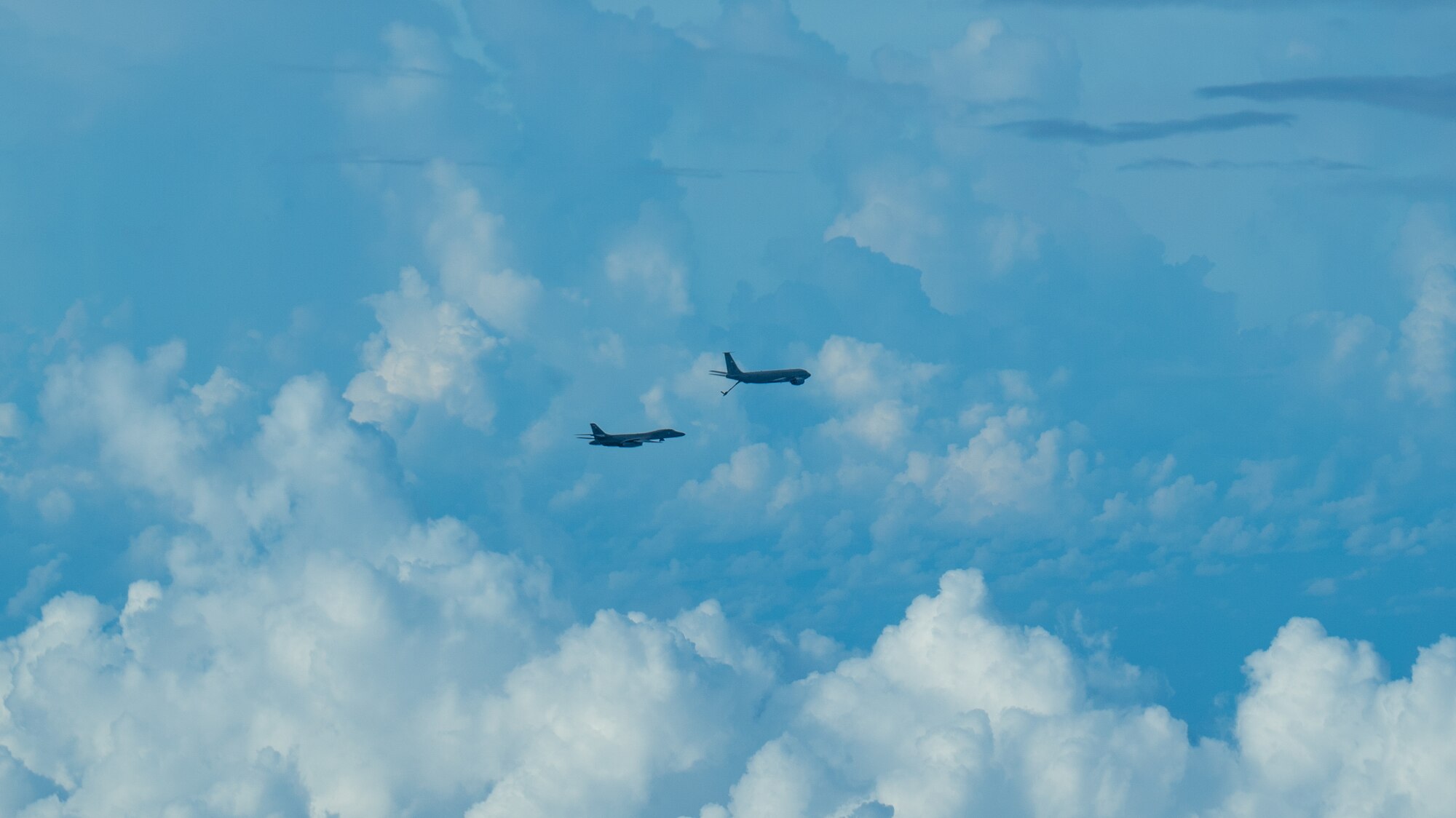 A U.S. Air Force B-1B Lancer assigned to the 37th Expeditionary Bomb Squadron, Ellsworth Air Force Base, South Dakota, receives fuel from a 909th Air Refueling Squadron KC-135 Stratotanker during a routine Bomber Task Force mission over the South China Sea, May 31, 2024. BTF missions provide opportunities to train and work with Allies and partners in joint and coalition operations and exercises. (U.S. Air Force photo by Senior Airman Cedrique Oldaker)