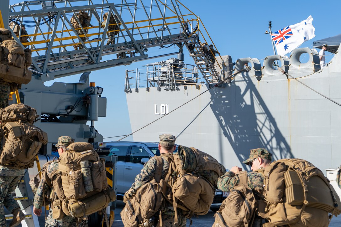 U.S. Marines and Sailors with Marine Rotational Force – Darwin 24.3 embark on HMAS Adelaide (L01) at Larrakeyah Defence Precinct, Darwin, NT, Australia, June 2, 2024. Marines and Sailors embarked on HMAS Adelaide (L01) alongside their Australian Allies to participate in the Wet and Dry Exercise Rehearsal, transiting from Darwin to Townsville from June 2-20, 2024. During WADER, elements from the MRF-D Marine Air-Ground Task Force will conduct MV-22B Osprey deck landing qualifications, a live-fire deck shoot, medical subject matter expert exchanges, enhance amphibious fires, command and control, and initiate a ship-to-shore movement in order to set conditions for future operational tasking. (U.S. Marine Corps photo by Gunnery Sgt. Kassie McDole)
