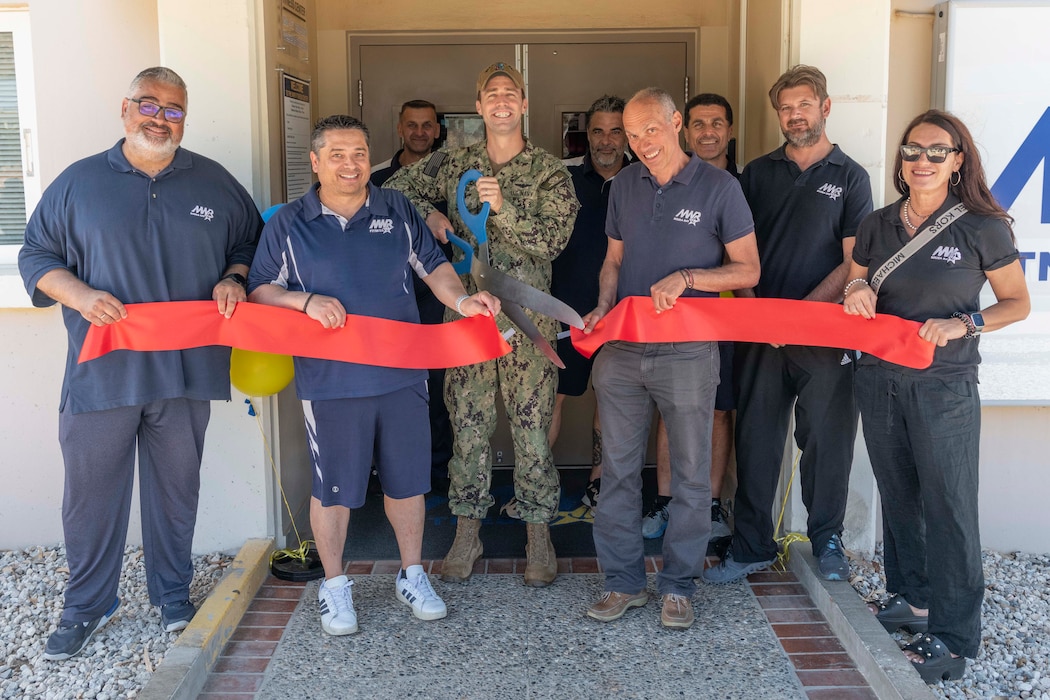 Cmdr. James Kotora, executive officer, Naval Support Activity Souda Bay and NSA Souda Bay Morale, Welfare, and Recreation employees cut a ceremonial ribbon to announce the fitness center’s 24/7  access on May 31, 2024.