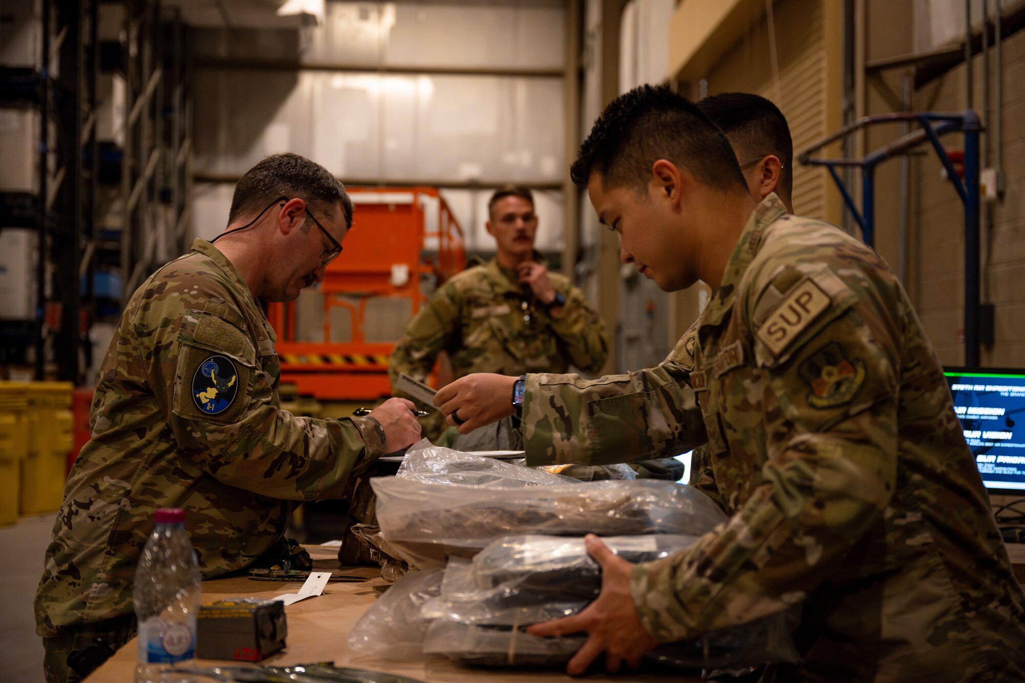 Airmen assigned to the 379th Air Expeditionary Wing turn in issued gear to the 379th Expeditionary Logistics Readiness Squadron Expeditionary Theater Distribution Center at an undisclosed location in the U.S. Central Command area of responsibility, May 31, 2024.