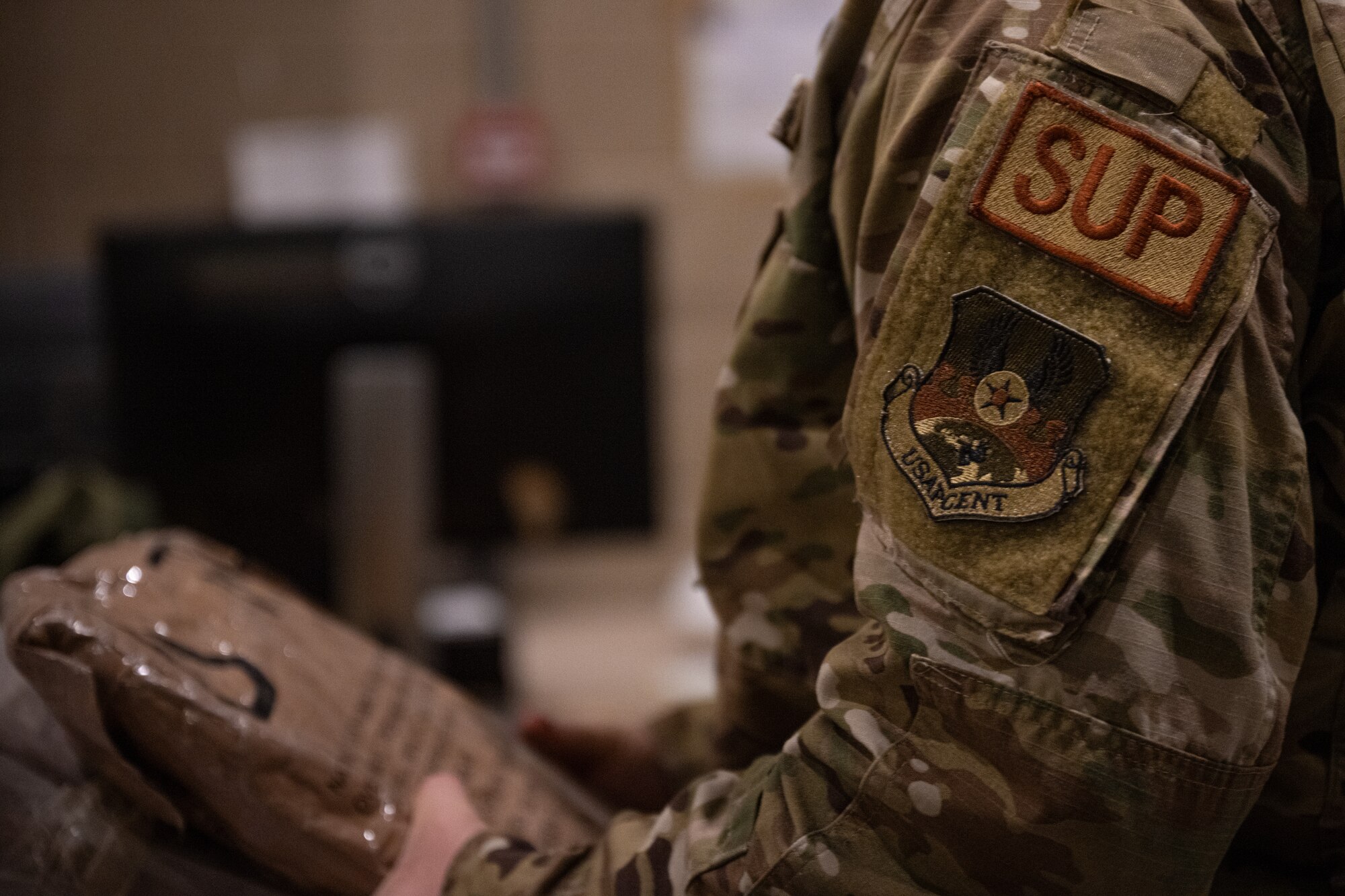 An Airman assigned to the 379th Expeditionary Logistics Readiness Squadron handles issued gear at an undisclosed location in the U.S. Central Command area of responsibility, May 31, 2024.