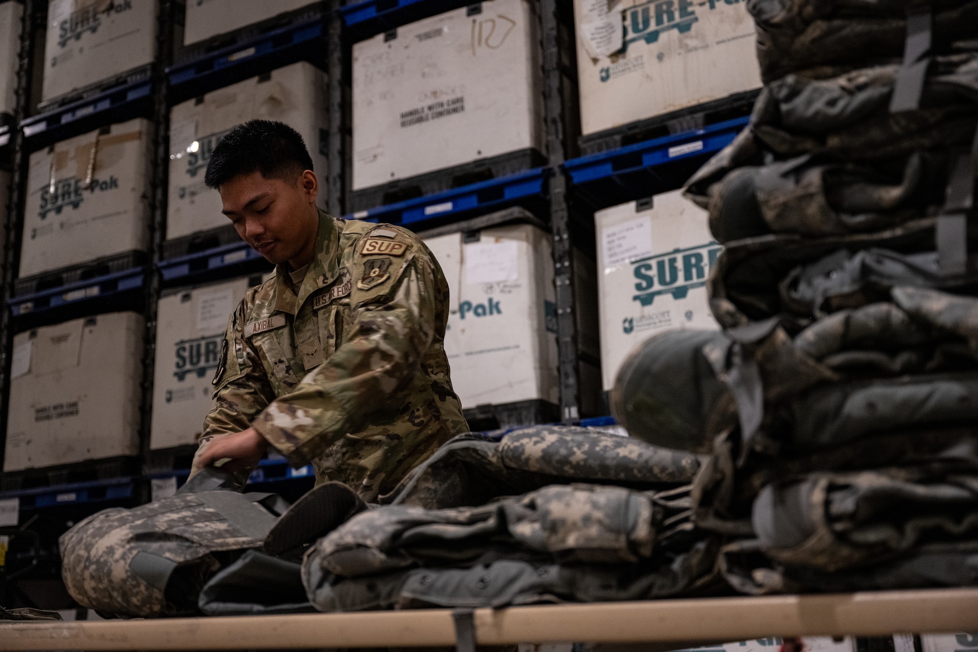 An Airman assigned to the 379th Expeditionary Logistics Readiness Squadron inspects a piece of a plate carrier at an undisclosed location in the U.S. Central Command area of responsibility, May 31, 2024.