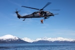 Alaska Air National Guard HH-60G Pave Hawk helicopter aviators assigned to the 210th Rescue Squadron hoist two 212th Rescue Squadron pararescuemen during hoist training in the Prince William Sound near Whittier, Alaska, May 15, 2024. The 212th, along with the 210th and 211th RQSs, make up the 176th Wing Rescue Triad and are among the busiest combat search and rescue units in the world.