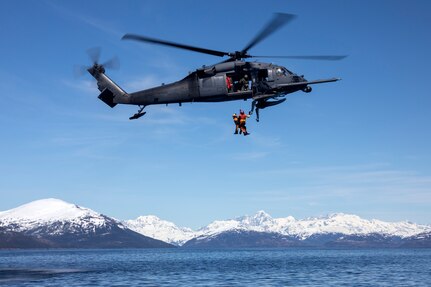 Alaska Air National Guard HH-60G Pave Hawk helicopter aviators assigned to the 210th Rescue Squadron hoist two 212th Rescue Squadron pararescuemen during hoist training in the Prince William Sound near Whittier, Alaska, May 15, 2024. The 212th, along with the 210th and 211th RQSs, make up the 176th Wing Rescue Triad and are among the busiest combat search and rescue units in the world.