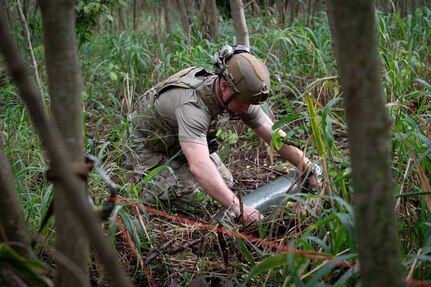 Hawaii Air National Guard Master Sgt. Dustin J. Frey, an explosive ordnance disposal technician from the 154th Civil Engineer Squadron, disarms munitions in a simulated weapons cache during exercise Pacific Warriorz 2024 at Bellows Air Force Station, Waimanalo, Hawaii, April 7, 2024.