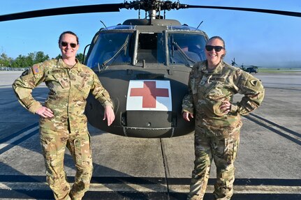 CW2 Lauren Bloch and CW3 Joy Byrnes, UH-60 Black Hawk pilots, District of Columbia National Guard, stand for a photograph at Davison Army Airfield, May 21, 2024. D.C. Army National Guard Aviation organized an all-female flight crew to commemorate the first woman to graduate Army flight school and the first female officer to achieve pilot status in June 1974.