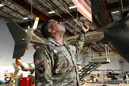 A member of the District of Columbia National Guard's Army Aviation Facility tows a UH-60 Black Hawk helicopter at Davison Army Airfield, May 21, 2024. D.C. Army National Guard Aviation organized an all-female flight crew to commemorate the first woman to graduate Army flight school and the first female officer to achieve pilot status in June 1974.