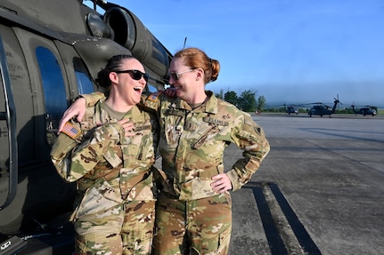 CW2 Lauren Bloch and CW3 Joy Byrnes, UH-60 Black Hawk pilots, District of Columbia National Guard, stand for a photograph at Davison Army Airfield, May 21, 2024. D.C. Army National Guard Aviation organized an all-female flight crew to commemorate the first woman to graduate Army flight school and the first female officer to achieve pilot status in June 1974.