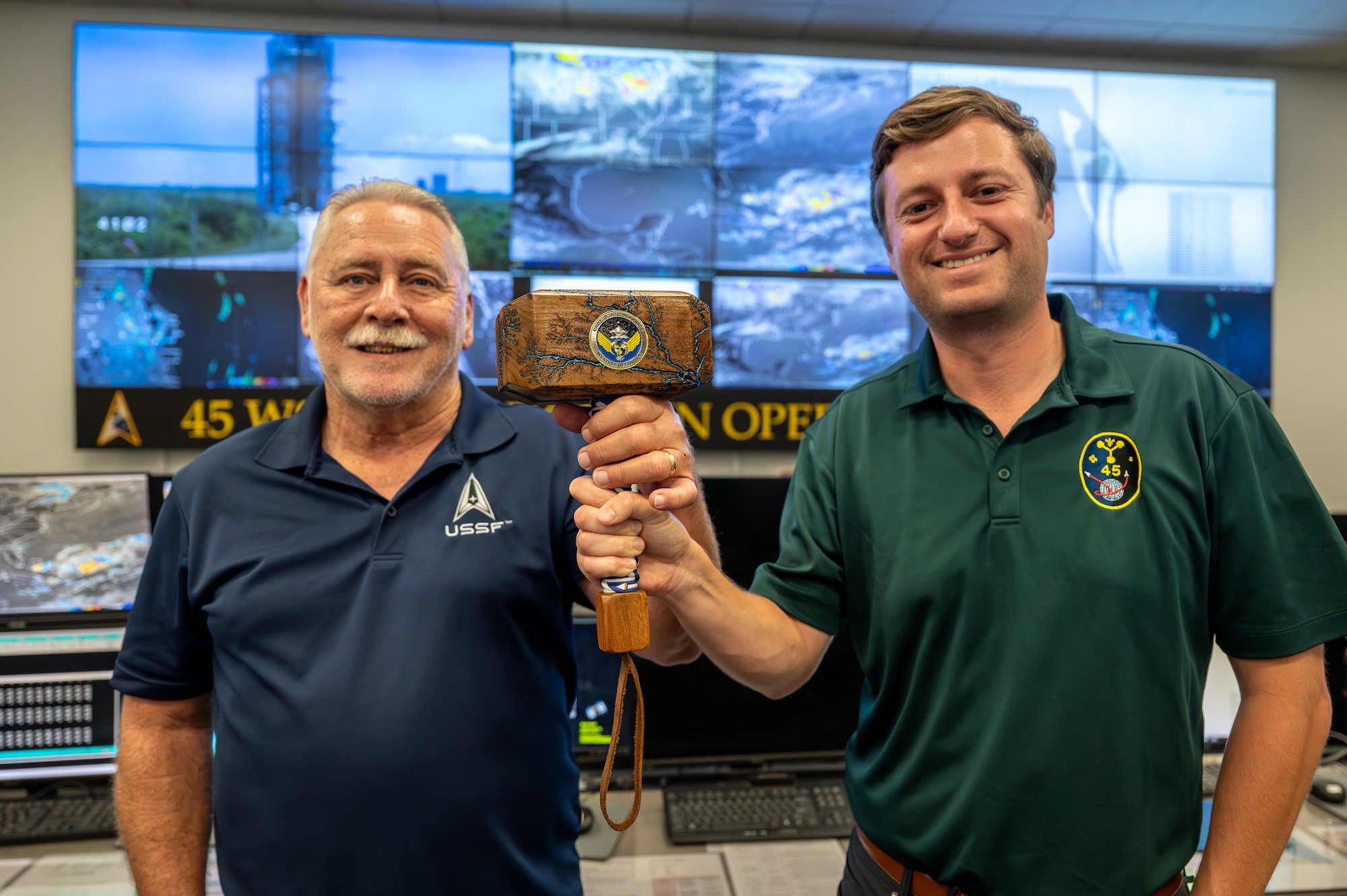 Tom Taylor, Chief of Training, Standardization, and Evaluation for the 45th Weather Squadron (left) and Brian Cizek, 45th Weather Squadron weather officer (right), pose with Thor’s Legions Forecast Challenge Trophy at Cape Canaveral Space Force Station, Florida, on May 21, 2024. The 45th Weather Squadron won first place, beating 47 teams comprising 253 forecasters.