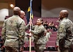 Soldier passes guidon to another Soldier