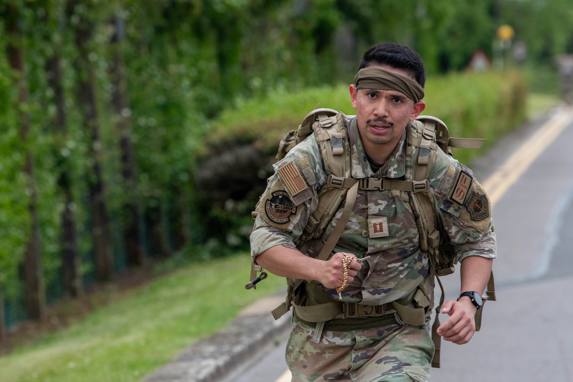 An Airman runs while holding a rosery