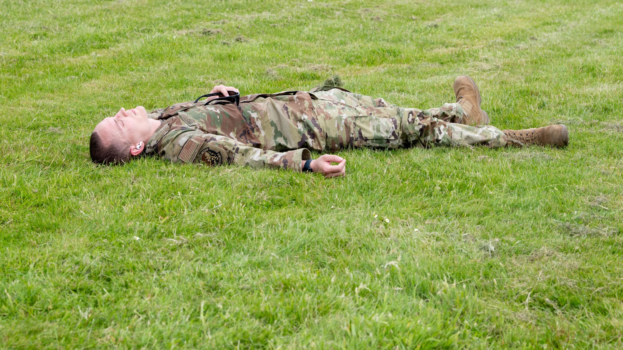 A competitor recovers in the grass after a Norwegian Foot March
