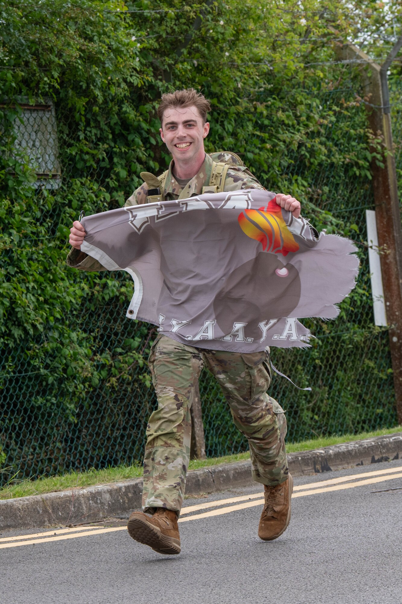 A competitor displays an AMMO flag during a Norwegian Foot March