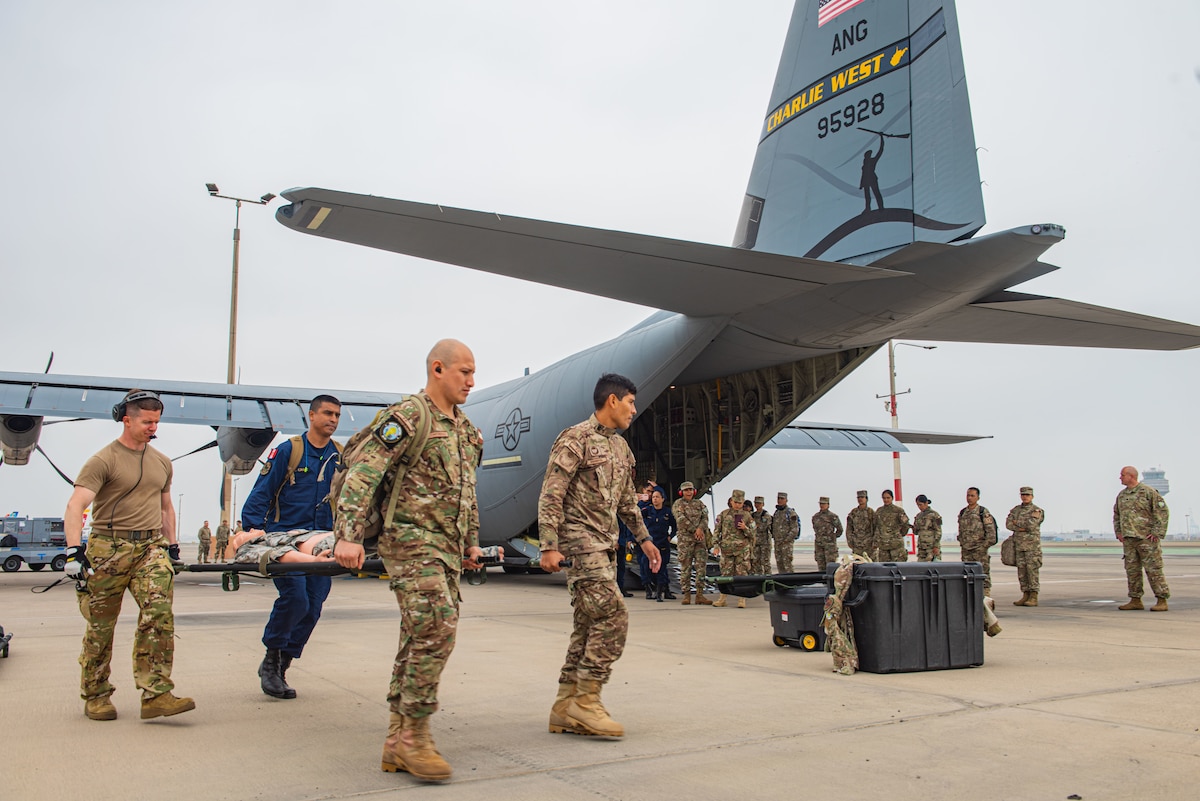 Airmen from the U.S. Air Force, Peruvian Air Force and Coast Guard, transport a simulated aeromedical evacuation patient during Resolute Sentinel 2024 in Lima, Peru, May 30, 2024. Exercise RS24 is an opportunity for cultural and tactical integration between the U.S. and its allied Latin American nations. (U.S. Air force photo by Airman 1st Class Sir Wyrick)