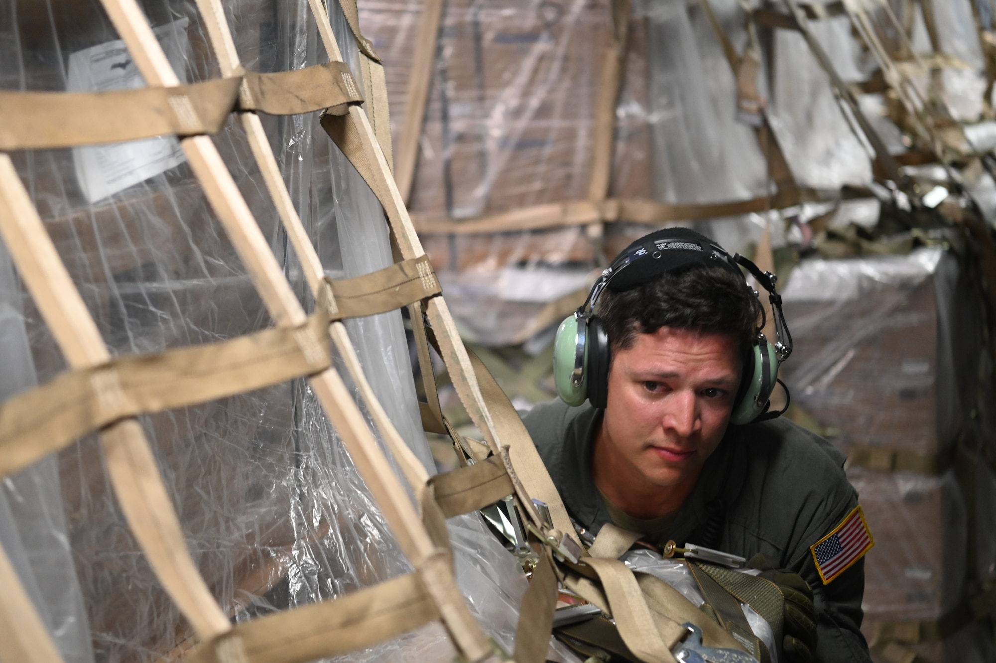 Master Sgt. Brent Bolin, a 68th Airlift Squadron loadmaster, pushes a pallet of humanitarian aid being offloaded from a 433rd Airlift Wing C-5M Super Galaxy at Panama Pacifico International Airport June 1, 2024.