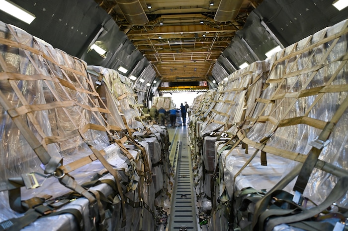 68th Airlift Squadron loadmasters and Panamanian airport workers unload pallets of humanitarian aid from a 433rd Airlift Wing C-5M Super Galaxy at Panama Pacifico International Airport June 1, 2024.