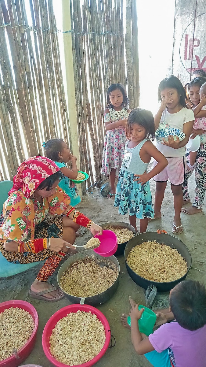 Panamanian children in a rural village on the San Blas Islands, Guna Yala district line up to eat food delivered to Panama, under the Department of Defense's Denton Humanitarian Assistance Program June 1, 2024.
