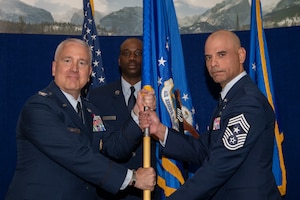 Chief Master Sgt. Manuel R. Zubia, Headquarters Air Reserve Personnel Center incoming command chief, assumes command chief responsibilities from Col. Jason Knight, HQ ARPC deputy commander, during a Change of Responsibility ceremony on Buckley Space Force Base, Colorado, May. 30, 2024.