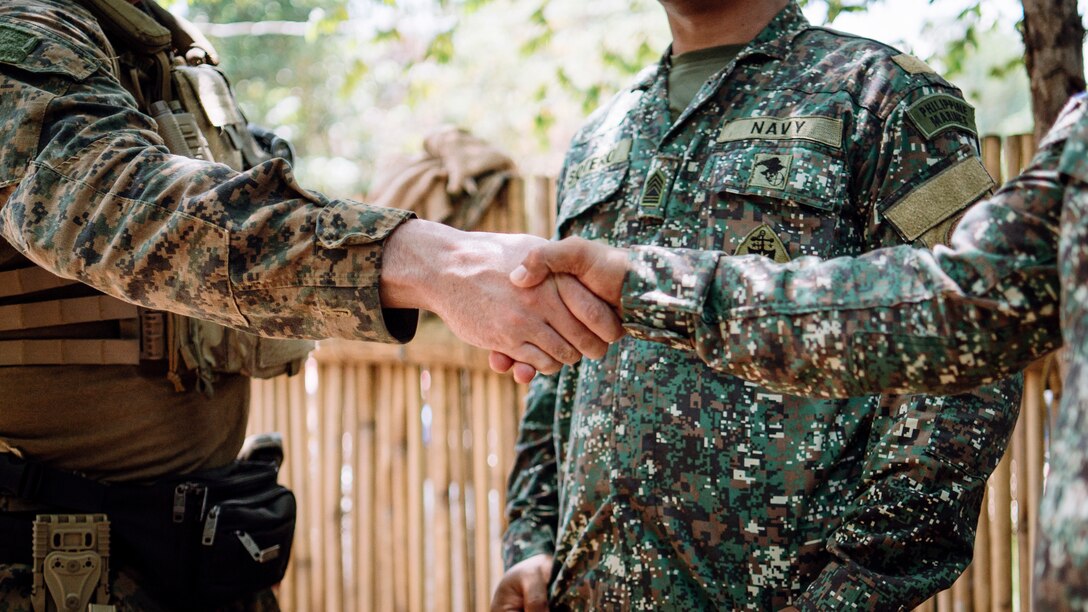 A U.S. Marine assigned to Maritime Reconnaissance Platoon, Reconnaissance Company, 15th Marine Expeditionary Unit, shakes hands with a Philippine Marine assigned to Marine Corps Assault Boat Battalion following a maritime domain awareness exchange during Archipelagic Costal Defense Continuum at San Vicente, Palawan, Philippines, May 18, 2024. ACDC is a series of bilateral exchanges and training opportunities between U.S. Marines and Philippine Marines aimed at bolstering the Philippine Marine Corps’ Coastal Defense strategy while supporting modernization efforts of the Armed Forces of the Philippines. (U.S. Marine Corps photo by Gunnery Sgt. Donald Holbert)
