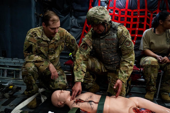Airmen evaluate patient.
