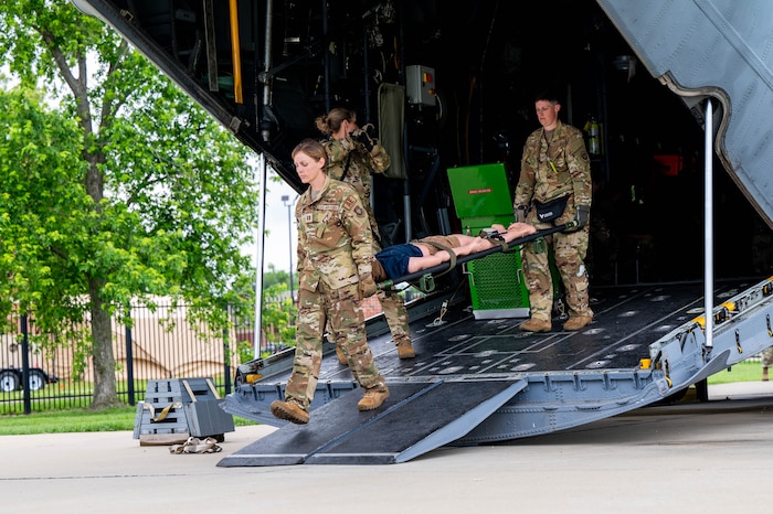 Airmen unload simulated patient.