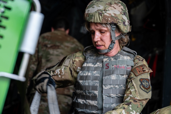 Airman adjusts straps.
