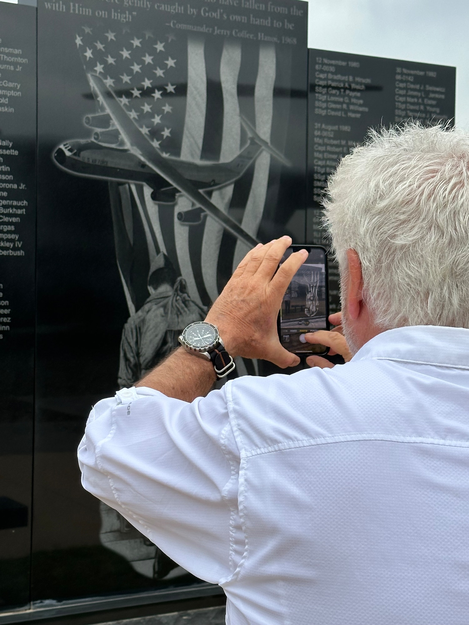 Retired U.S. Air Force Lt. Col. Herbert Bailey photographs the C-141 Starlifter aircraft memorial at Altus Air Force Base, Oklahoma, April 15, 2024. This was Bailey’s first time viewing the memorial featuring his artwork in person. (U.S. Air Force photo by Nicole Valence)