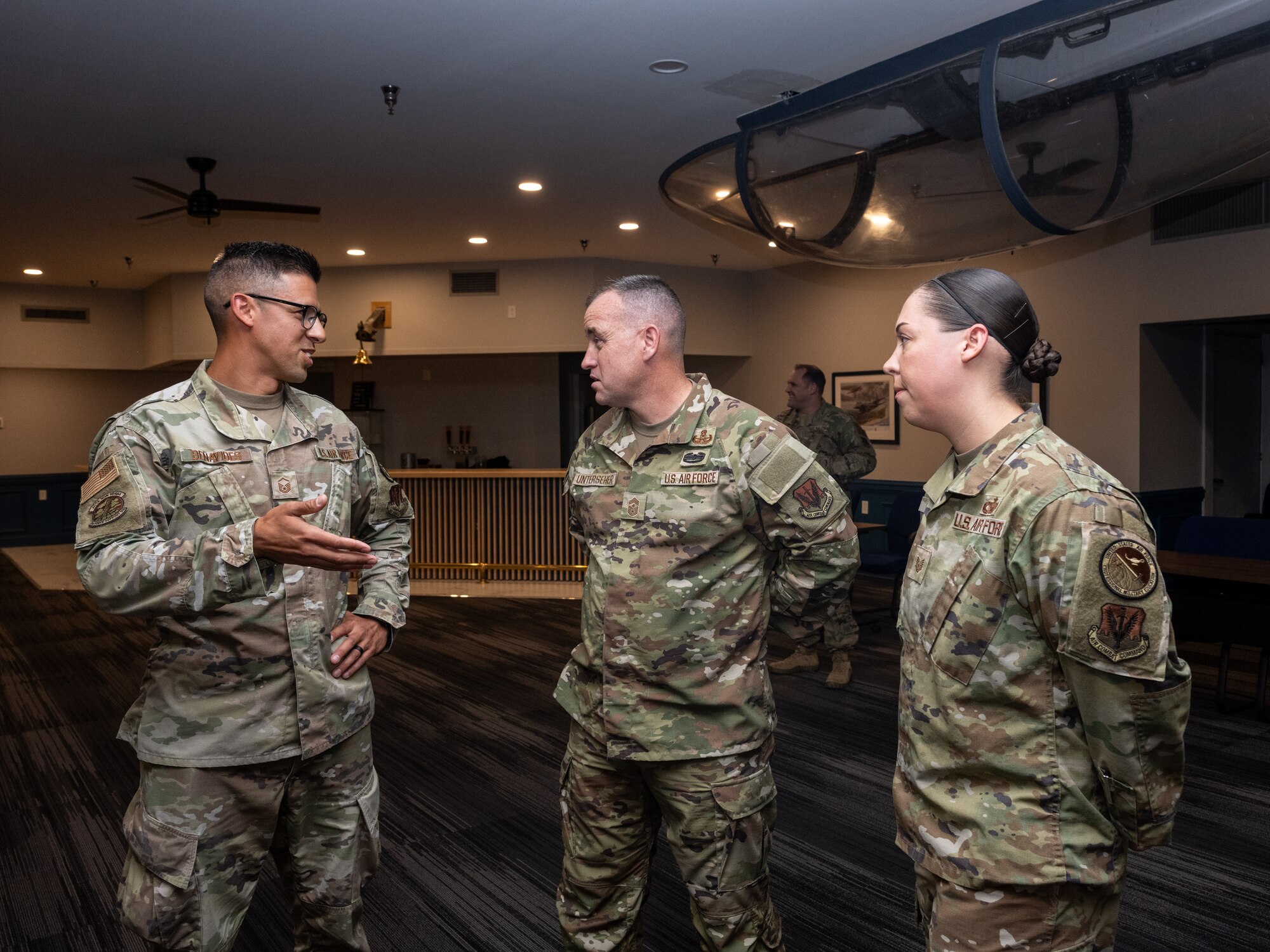 U.S. Air Force Chief Master Sgt. Jeremy Unterseher, Fifteenth Air Force command chief, Master Sgt. Mark Benavides, Airman Leadership School commandant, right, and Tech Sgt. Devin Pope, ALS instructor supervisor, left, discusses the successful impact ALS has on Airmen at Seymour Johnson Air Force Base, North Carolina, May 21, 2024. Unterseher toured Seymour Johnson AFB to gain an in-depth understanding of the 4th Fighter Wing’s infrastructure, witness their routine activities and interact with committed Airmen on base. (U.S. Air Force photo by Airman Megan Cusmano)