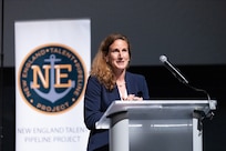 Meganne Atkins, executive director, AUKUS Integration and Acquisition Office, provides the keynote address during the National Signing Day event held at the New England Aquarium in Boston, Mass. on May 30. The U.S. Navy Submarine Industrial Base program along with local shipbuilding companies and suppliers, elected officials, and community leaders gathered to celebrate the future of the defense workforce during the inaugural event. The National Signing Day concluded a series of five Talent Pipeline Program events across key maritime hubs, honoring the latest group of talent joining the Defense Industrial Base.