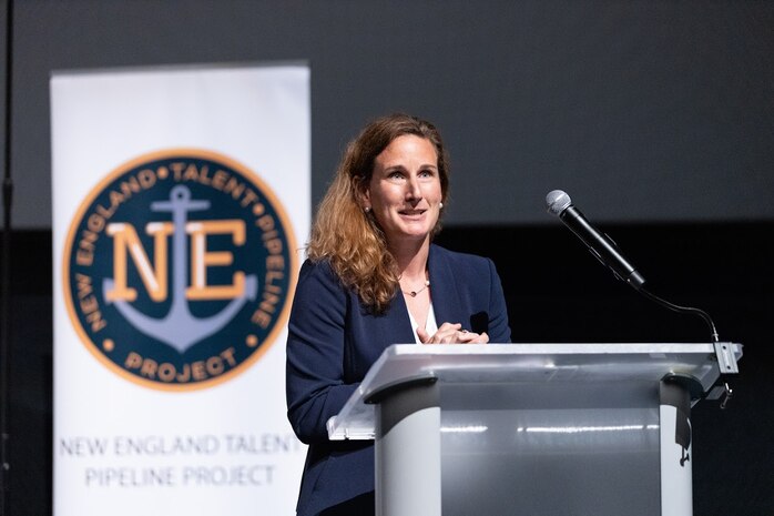 Meganne Atkins, executive director, AUKUS Integration and Acquisition Office, provides the keynote address during the National Signing Day event held at the New England Aquarium in Boston, Mass. on May 30. The U.S. Navy Submarine Industrial Base program along with local shipbuilding companies and suppliers, elected officials, and community leaders gathered to celebrate the future of the defense workforce during the inaugural event. The National Signing Day concluded a series of five Talent Pipeline Program events across key maritime hubs, honoring the latest group of talent joining the Defense Industrial Base.