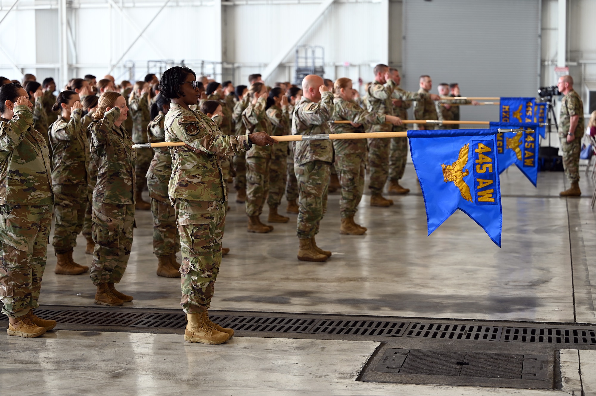 445th Airlift Wing Reserve Citizen Airmen salute during the singing of the National Anthem conducted during the 445th Airlift Wing Assumption of Command Ceremony held at Wright-Patterson Air Force Base, Ohio June 1, 2024. Col. Douglas Perry, Jr., assumed command of the wing after serving as the commander of the 434th Operations Group, Grissom Air Reserve Base, Indiana. (U.S. Air Force photo/Master Sgt. Patrick O’Reilly)