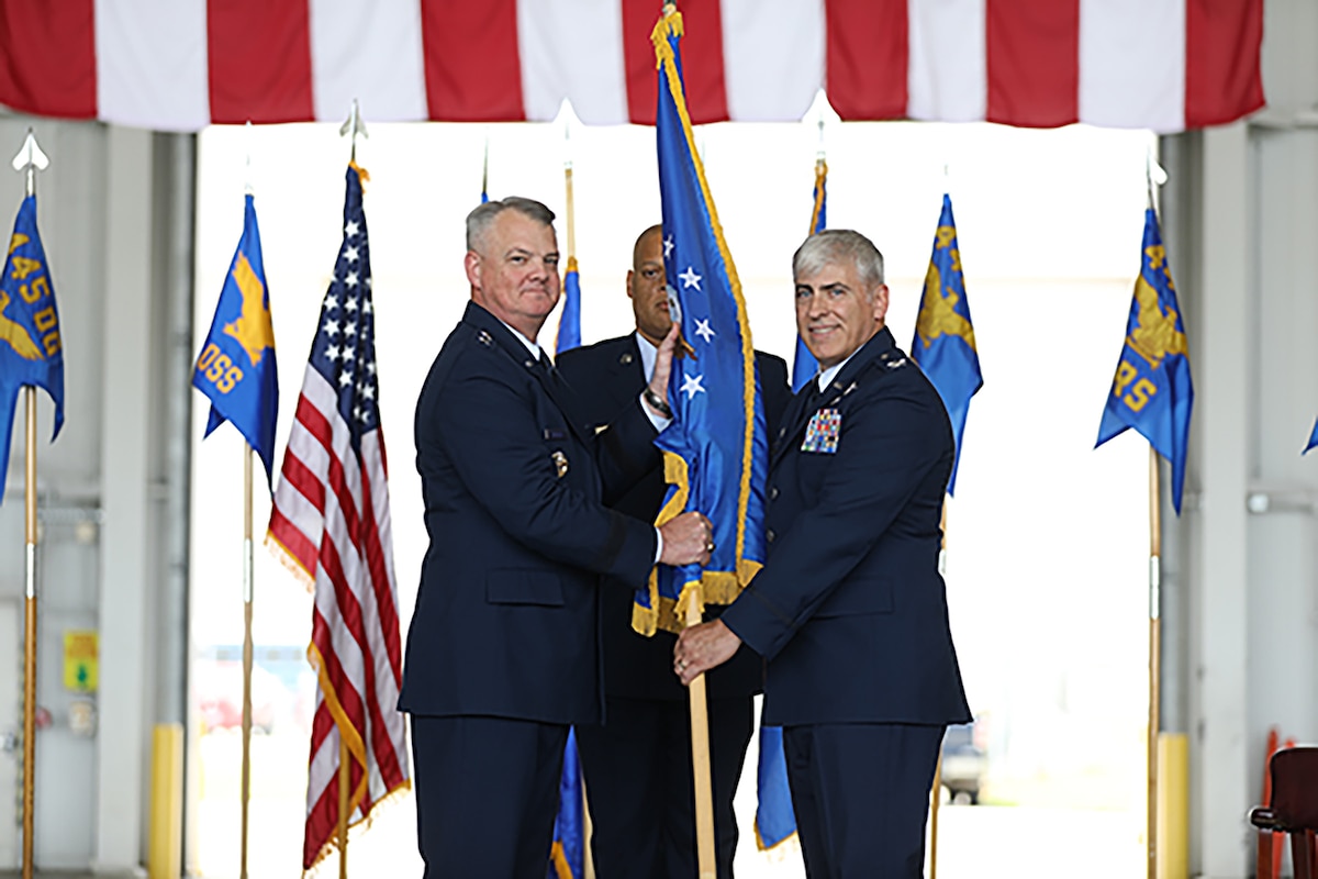 Maj. Gen. D. Scott Durham, Fourth Air Force commander, passes the guidon to Col. Douglas Perry, Jr., incoming 445th Airlift Wing commander, during the wing’s assumption of command ceremony held at Wright-Patterson Air Force Base, Ohio June 1, 2024. Prior to his arrival to the 445th AW, Colonel Perry served as the commander of the 434th Operations Group, Grissom Air Reserve Base, Indiana. (U.S. Air Force photo/Senior Airman Angela Jackson)