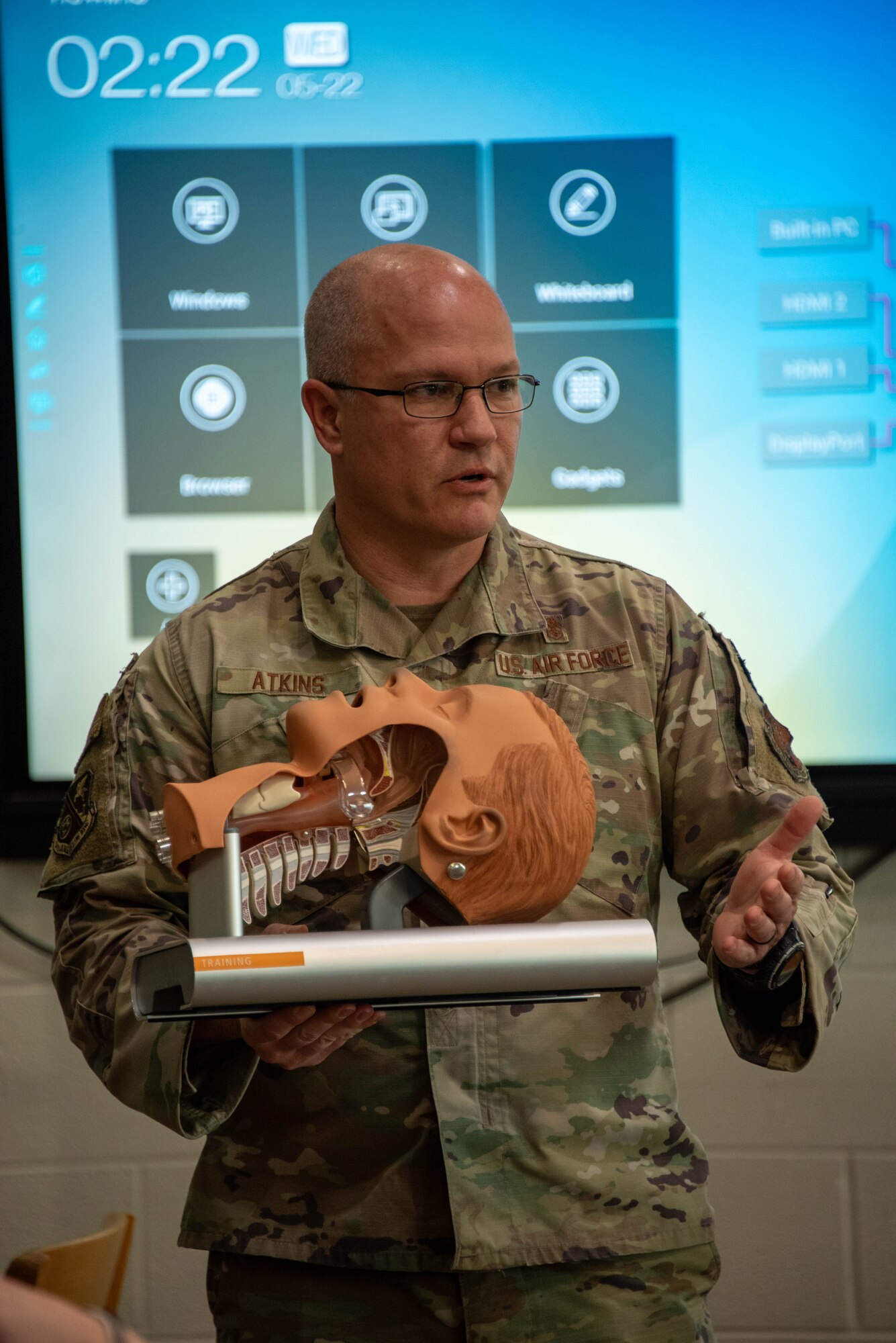 A man holds a model of the respiratory system