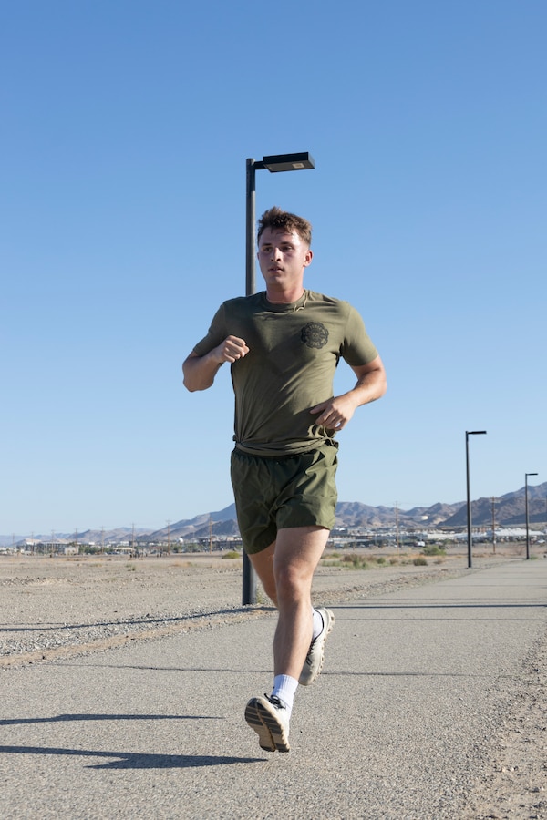 U.S. Marine Corps Cpl. Travis Martin, a motor vehicle operator with Headquarters Company, 7th Marine Regiment, 1st Marine Division, conducts a timed three-mile run, as one of the components of a physical fitness test at Marine Corps Air-Ground Combat Center, Twentynine Palms, California, May 30, 2024. The PFT evaluates stamina and physical conditioning through three components: pull-ups or push-ups, plank, and a three-mile timed run. (U.S. Marine Corps photo by Lance Cpl. Enge You)