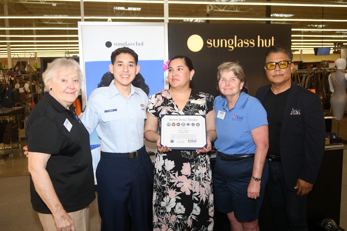 Caryl Hill, Employer Support of the Guard and Reserve Southern Region director, Senior Airman Arthur Tovar, 433rd Civil Engineer Squadron Air Force Reservist, Ms. Nancy Olguin, Sunglass Hut manager, Ms. Kerry Reyna, ESGR Awards Team Leader and Mr. Sergio Hernandez, Sunglass Hut manager, gather April 19, 2024 after Olguin receives the Seven Seals Award.