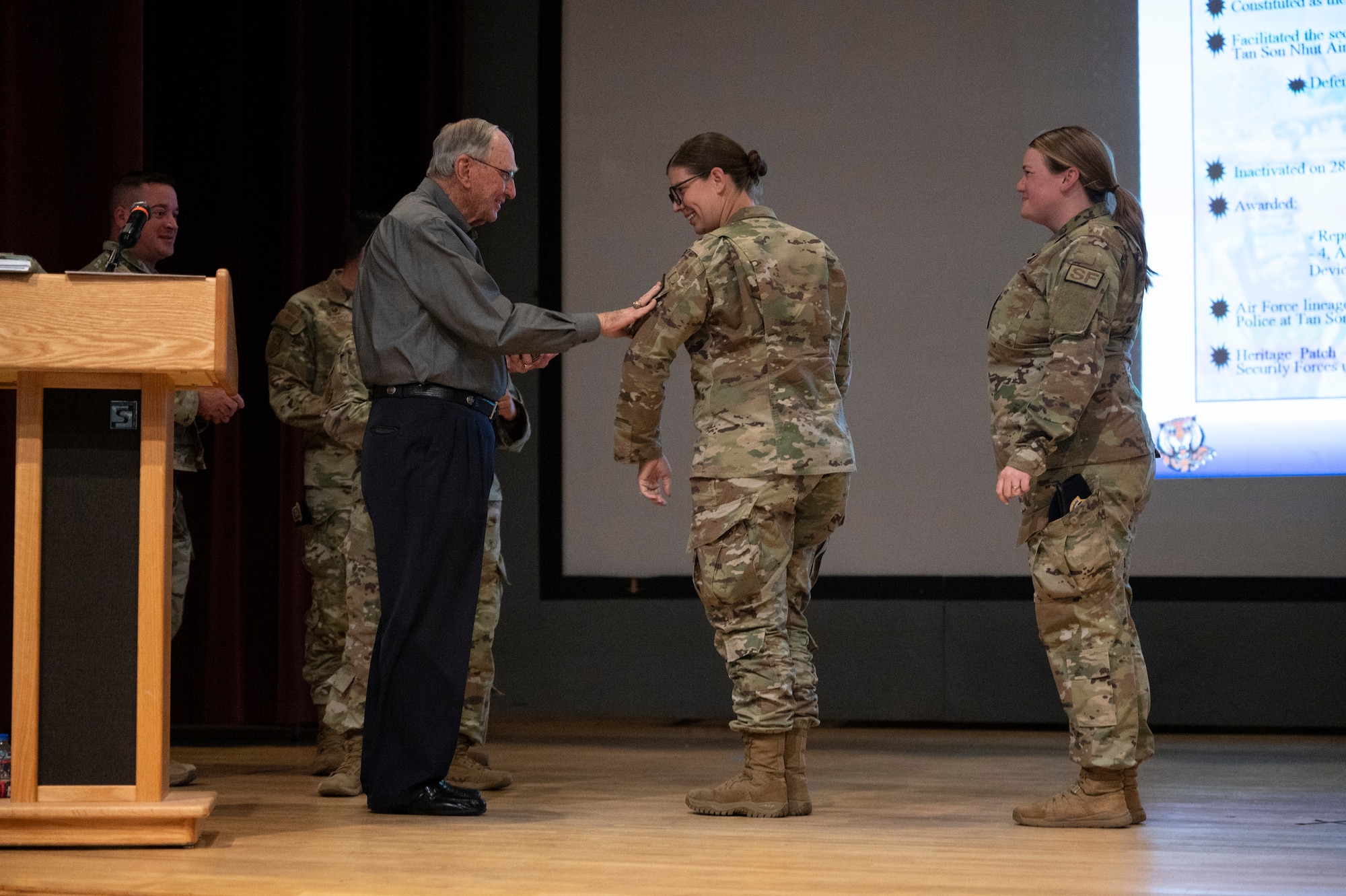 A man places a patch on a woman.
