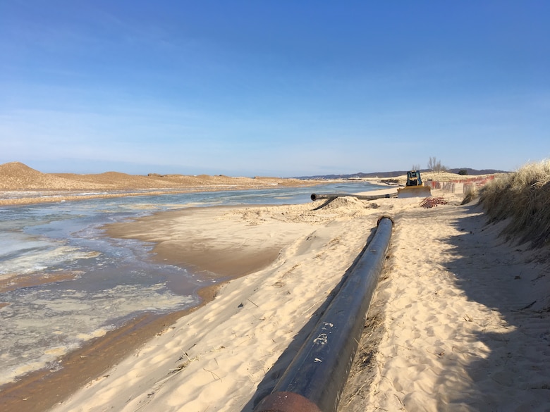 Sand is placed on the beach in Saugatuck, Michigan during dredging operations in this 2019 file image. The U.S. Army Corps of Engineers, Detroit District will begin maintenance dredging Saugatuck Harbor next week to improve the federal channel. (U.S. Army Corps of Engineers photo)