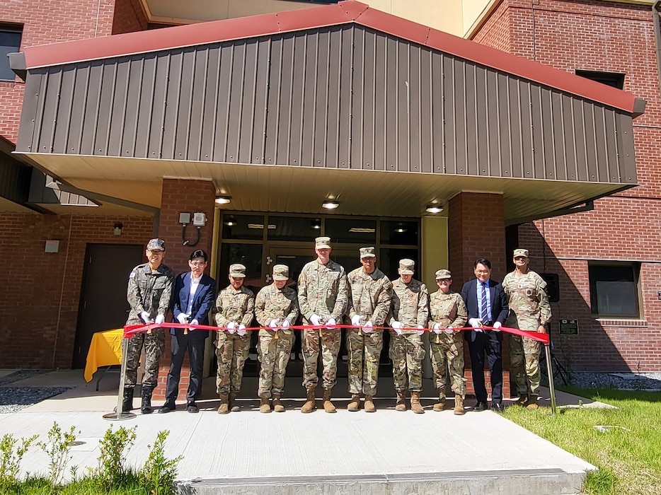 Col. Ryan Workman (fifth from left), U.S. Army Garrison Humphreys commander; Col. Heather Levy (third from right), commander of the U.S. Army Corps of Engineers – Far East District; Lee Gil-ju (second from right), Director of Project Management Division, Ministry of National Defense – Defense Installation Agency; and other distinguished guests cut the ribbon for the new Humphreys barracks for unaccompanied enlisted Soldiers, May 31, 2024. The two new barracks towers will house 302 personnel in individual rooms along with shared kitchens and bathrooms for every two Soldiers to provide high-quality living conditions. (US Army photo by Kim Chong-yun)