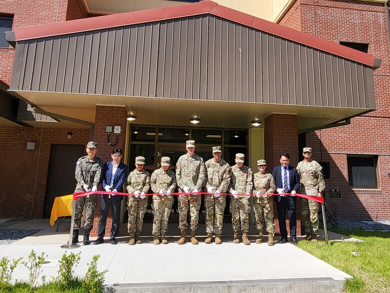 Col. Ryan Workman (fifth from left), U.S. Army Garrison Humphreys commander; Col. Heather Levy (third from right), commander of the U.S. Army Corps of Engineers – Far East District; Lee Gil-ju (second from right), Director of Project Management Division, Ministry of National Defense – Defense Installation Agency; and other distinguished guests cut the ribbon for the new Humphreys barracks for unaccompanied enlisted Soldiers, May 31, 2024. The two new barracks towers will house 302 personnel in individual rooms along with shared kitchens and bathrooms for every two Soldiers to provide high-quality living conditions. (US Army photo by Kim Chong-yun)