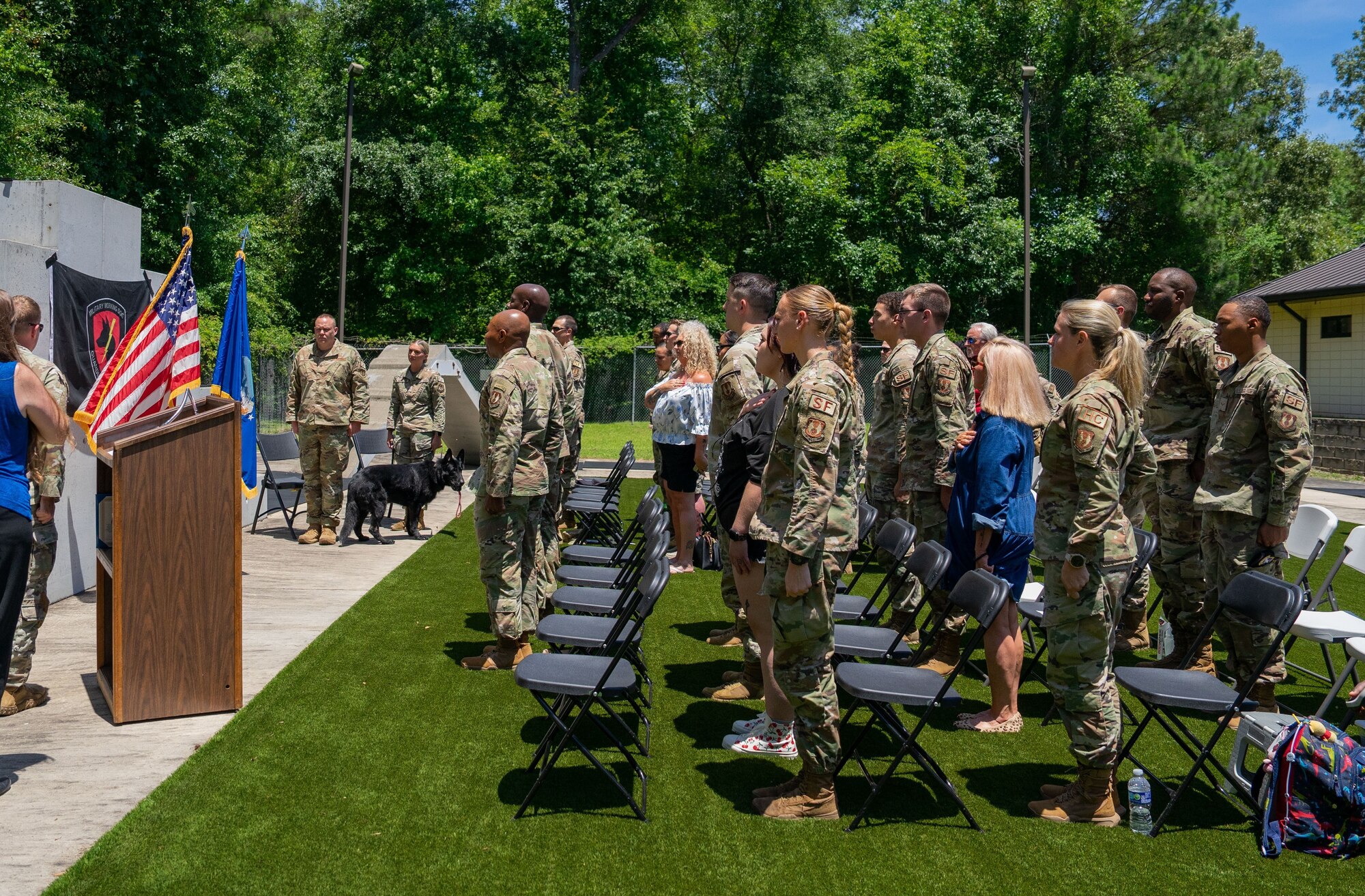 A group of people stand facing forward