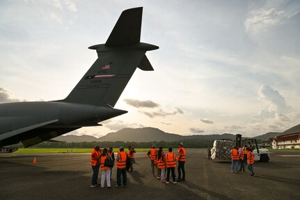 Members of King’s Castle Foundation (Fundación Castillo Del Rey), a Panamanian non-governmental organization dedicated to feeding the poor, observe as 68th Airlift Squadron loadmasters work with Panamanian airport workers to unload humanitarian aid from a 433rd Airlift Wing C-5M Super Galaxy at Panama Pacifico International Airport June 1, 2024.