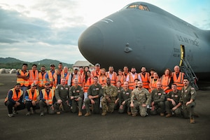 The 68th Airlift Squadron crew, call sign “Reach 2087”, which delivered 166,000 pounds of humanitarian aid to Panama pose for a group photo with members of King’s Castle Foundation (Fundación Castillo Del Rey), a Panamanian non-governmental organization distributing the aid to those in need, on the tarmac at Panama Pacifico International Airport June 1, 2024.