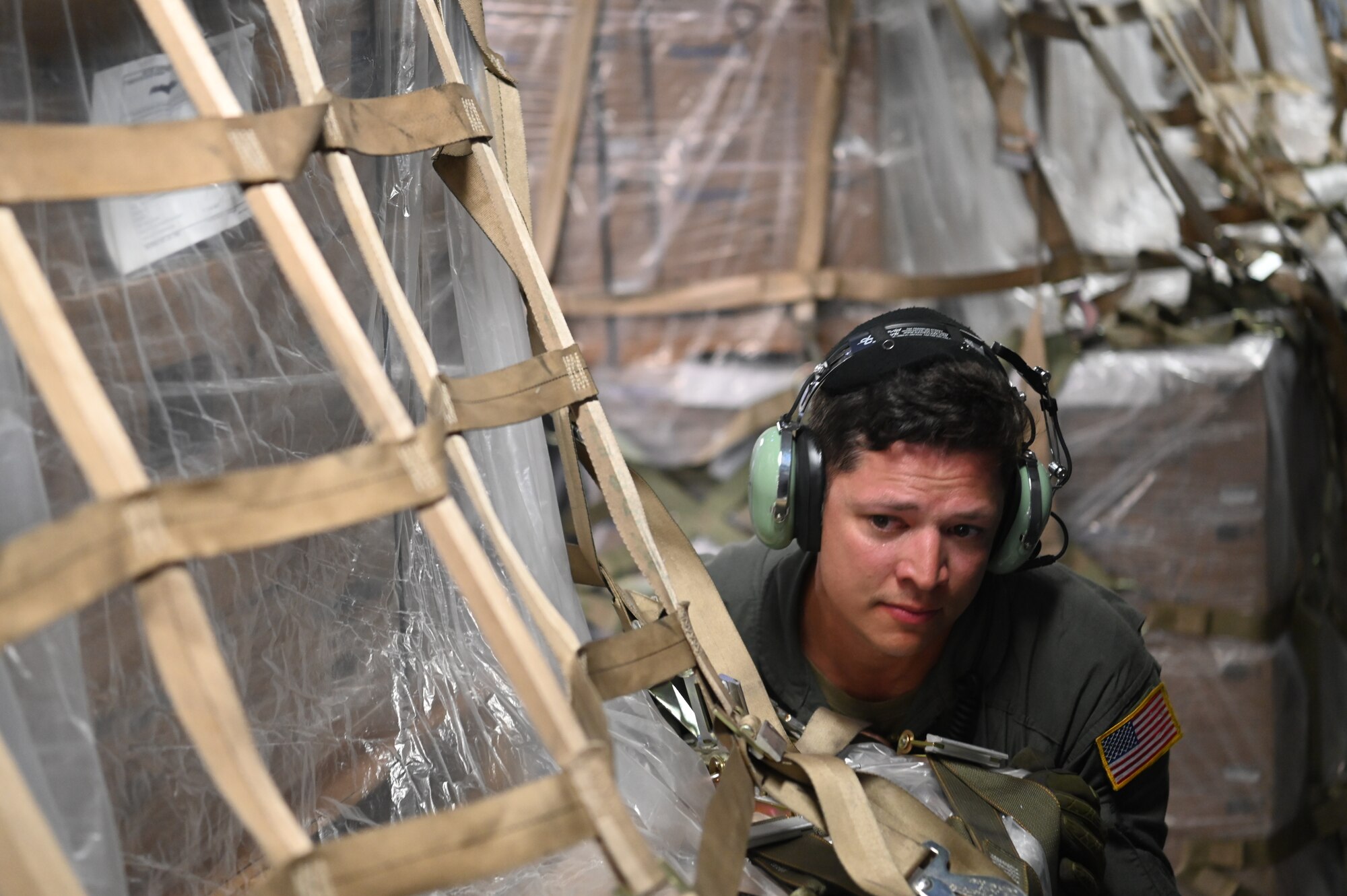 Master Sgt. Brent Bolin, a 68th Airlift Squadron loadmaster, pushes a pallet of humanitarian aid being offloaded from a 433rd Airlift Wing C-5M Super Galaxy at Panama Pacifico International Airport June 1, 2024.