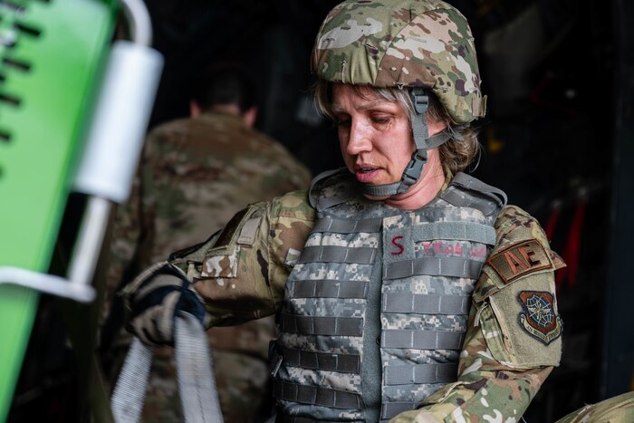Airman adjusts straps.