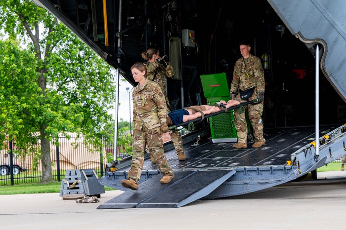 Airmen unload simulated patient.